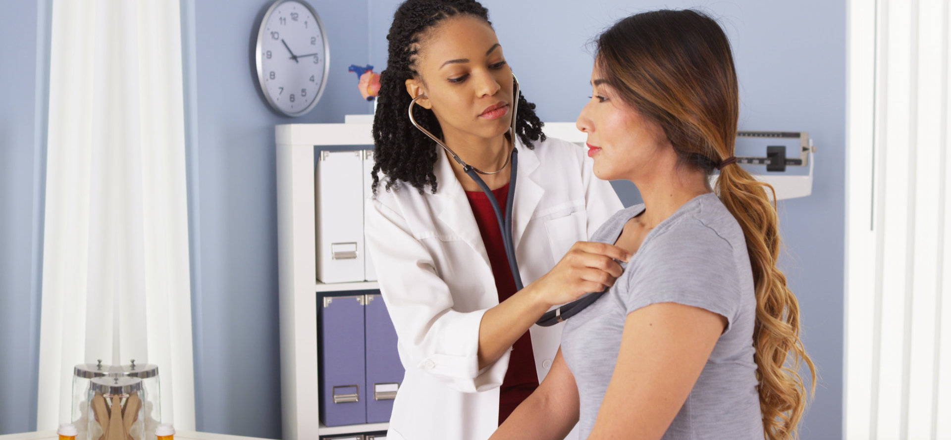 female doctor checking her patient's condition